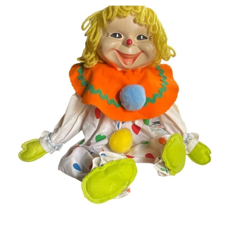 Vintage smiling happy sitting clown toy